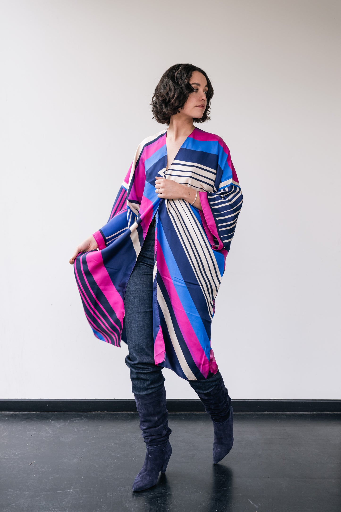 woman wears blue-pink silk kimono with stripes.