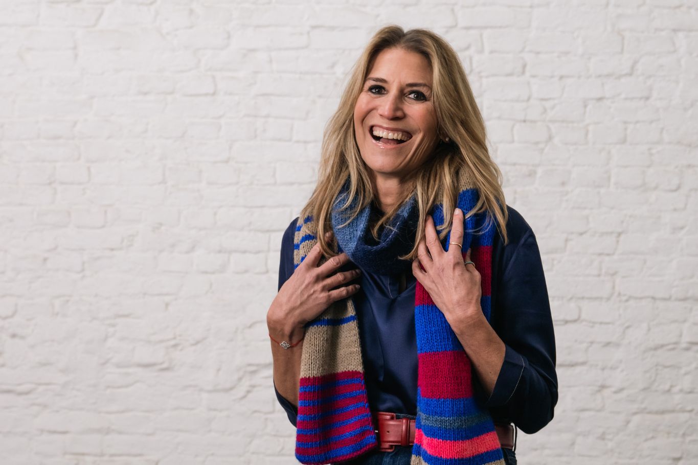 Smiling woman wearing a wool blue scarf
