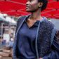 women wearing a dark blue silk fluffy vest, silk blouse, leather belt and oversized jeans