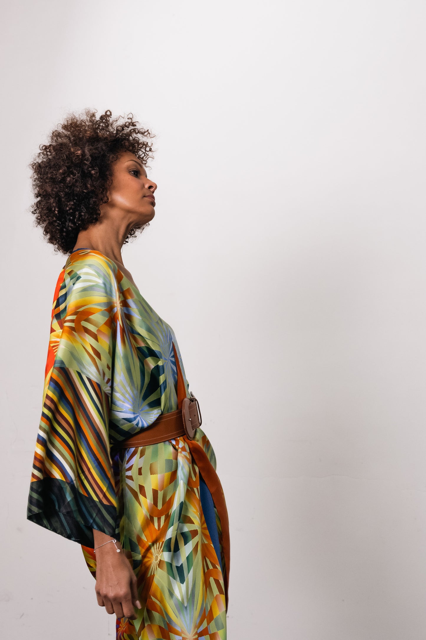 woman wearing a colorful silk kimono topped with a leather wide belt