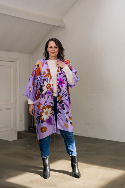 woman wears lilac silk long kimono with flowers. 