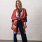 woman wearing bordeaux silk kimono with graphic print. belt is bordeaux and has a white resin buckle