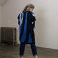 woman wears a blue wool cardigan with print