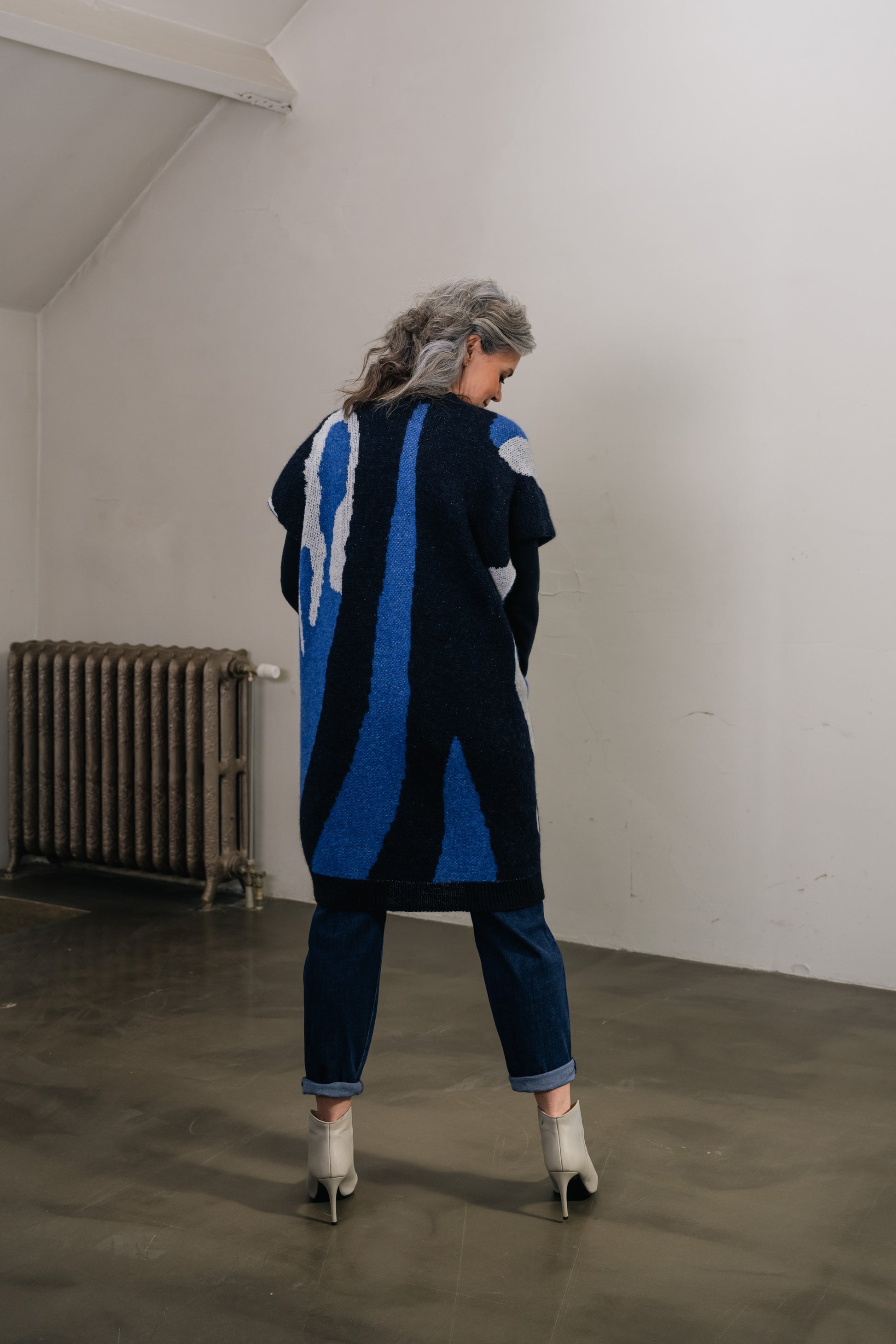 woman wears a blue wool cardigan with print