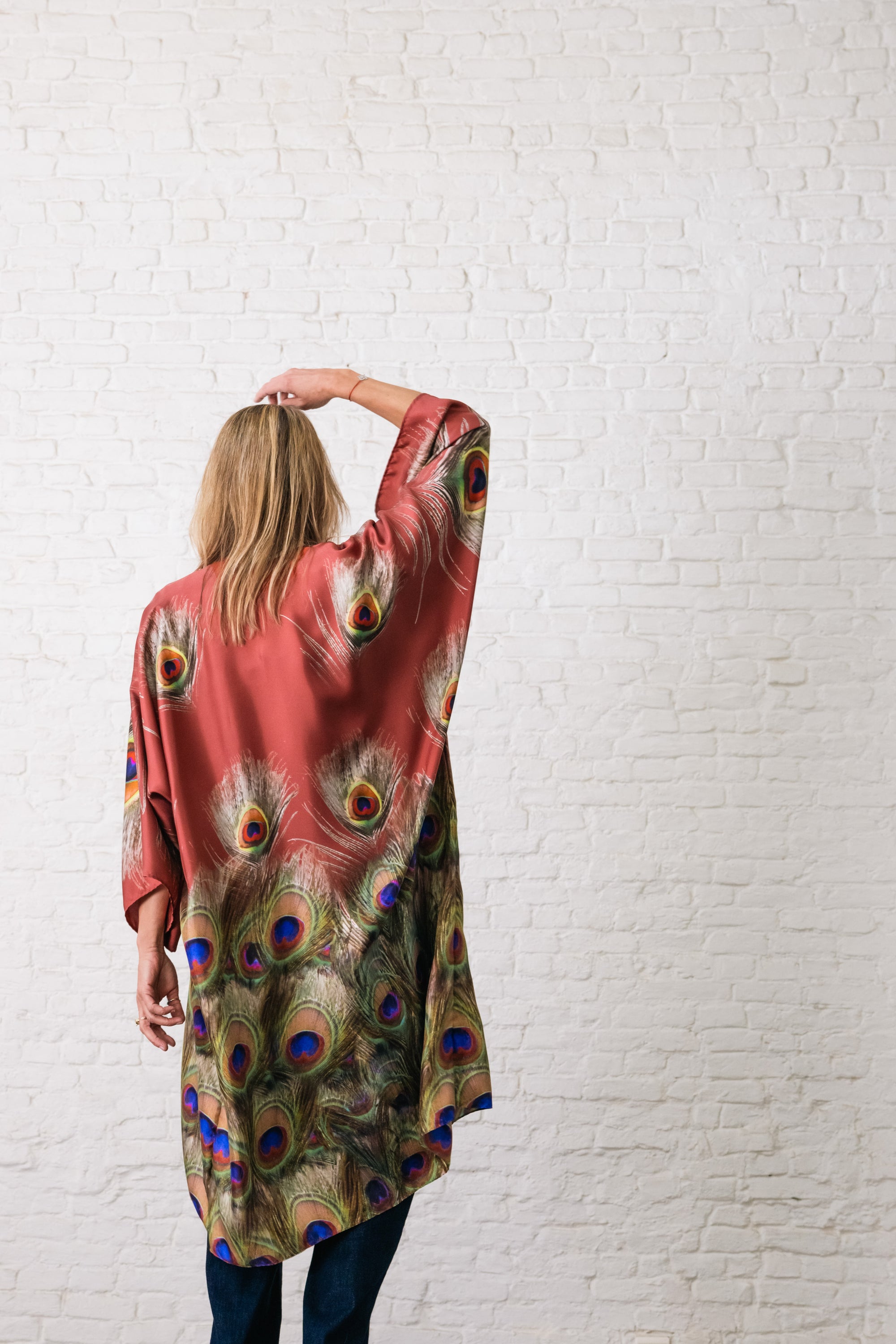woman wearing bordeaux silk kimono with graphic print. belt is bordeaux and has a white resin buckle