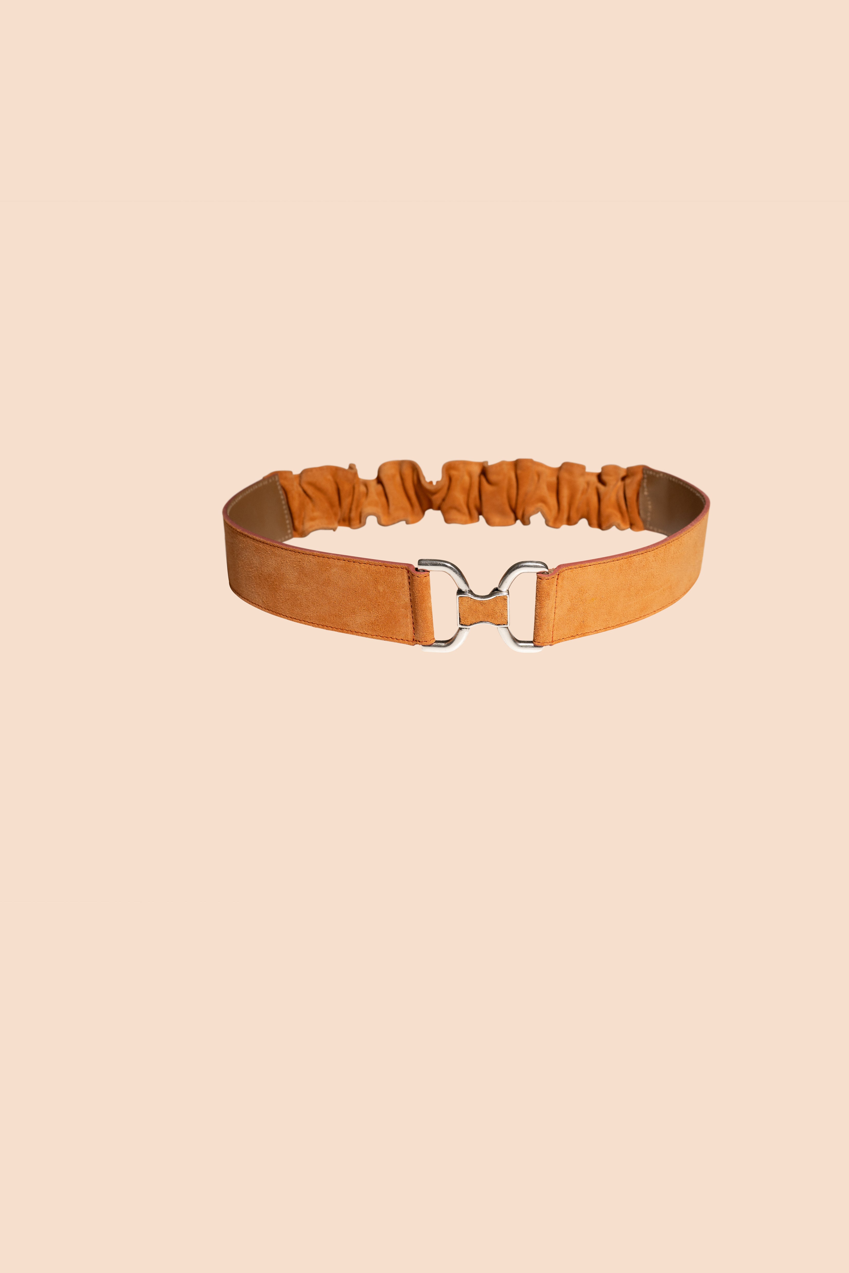 Leather belt with elastic back, with metal closure. colour of the belt is orange