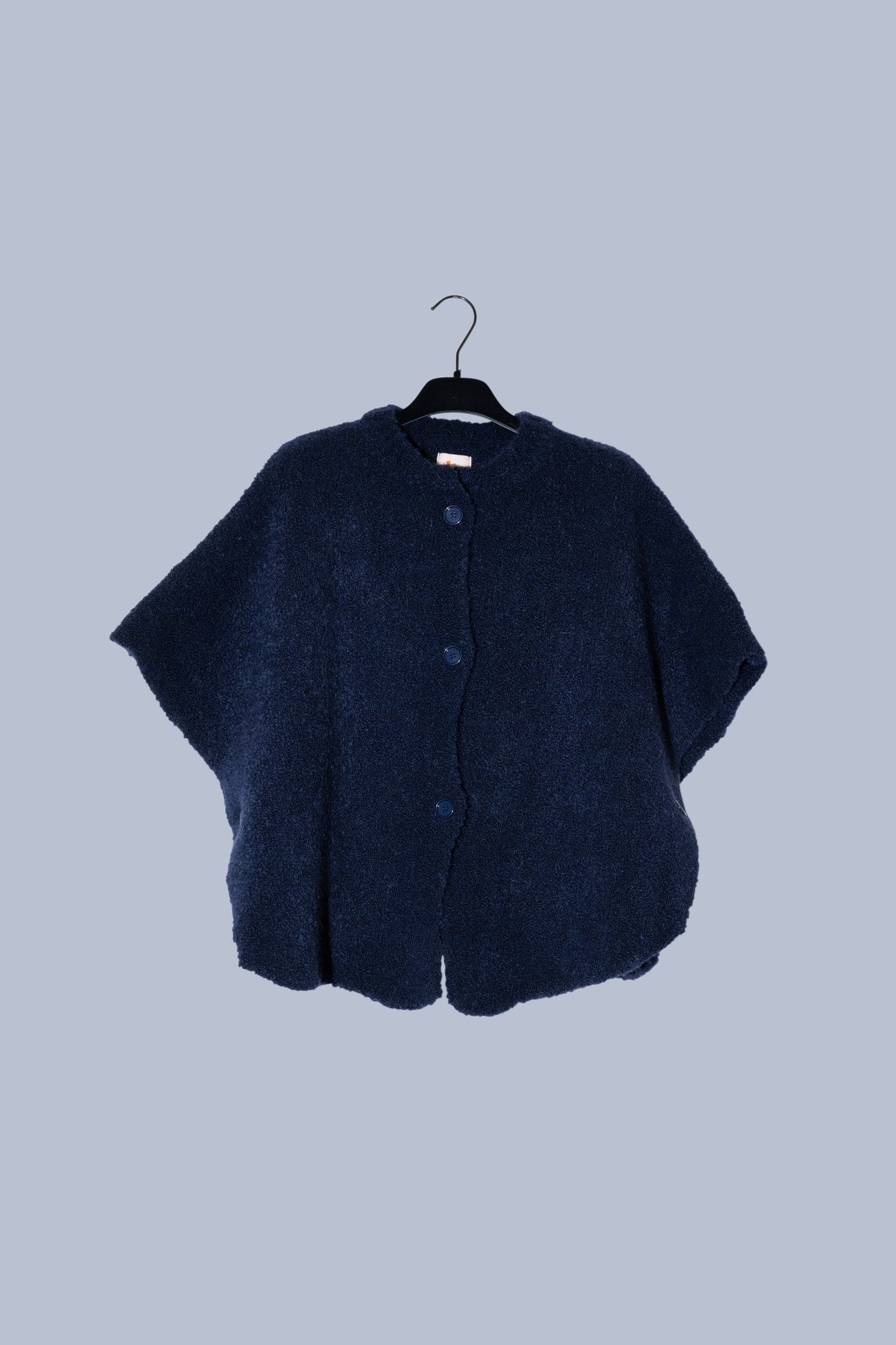 packshot of a dark blue wool cape